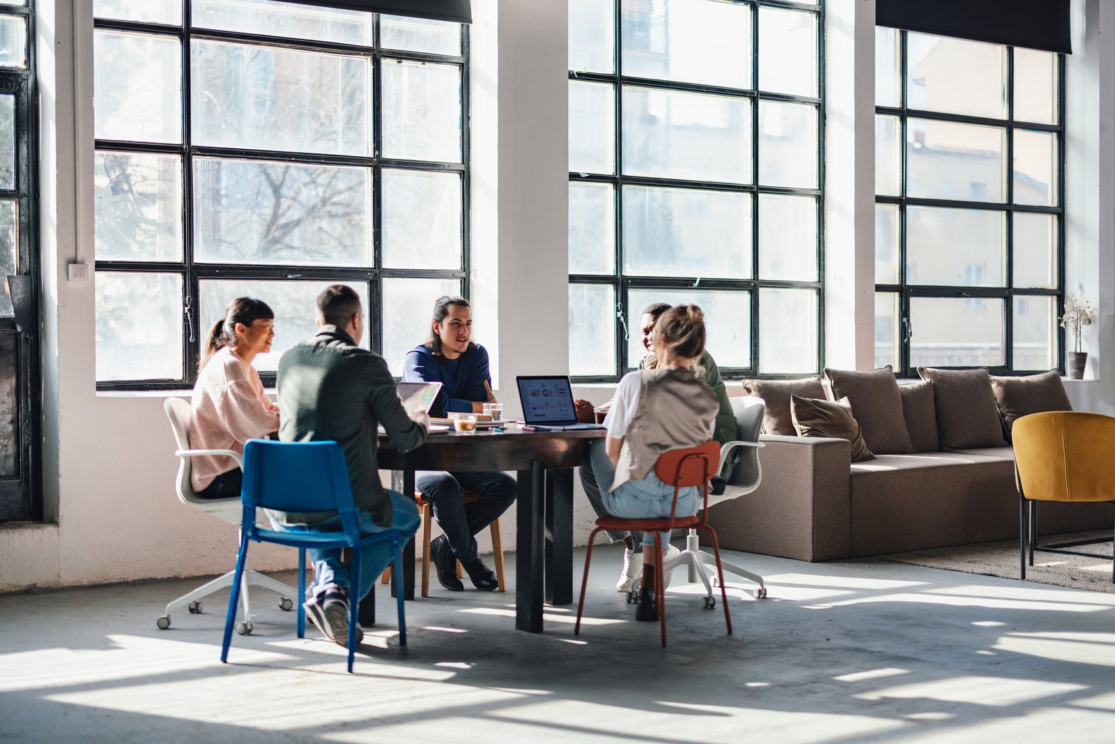 Young Professionals Collaborating in Modern Co-Working Space